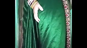 Indian crossdresser Gaurisissy in a green saree stimulates her body and engages in anal play