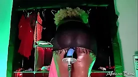 Close-up view of ebony beauty riding a dildo on a fuck machine