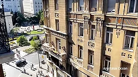 Emerald Ocean's public nudity video features a woman undressing on a city balcony
